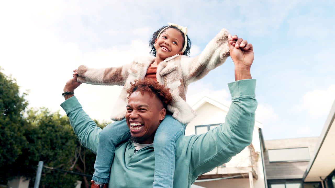 Happy Father Giving Daughter a Piggyback Ride Outdoors