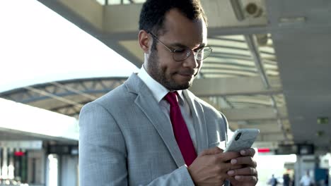 Businessman-texting-via-cell-phone