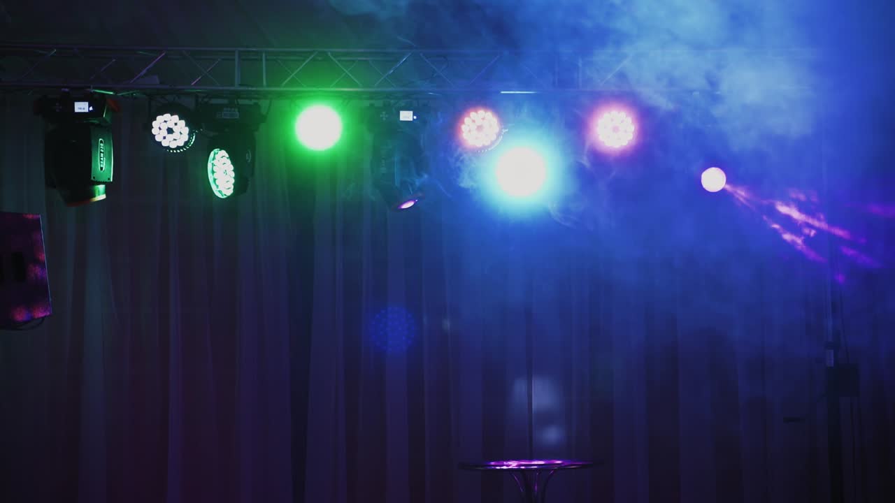 Spotlights and lighting equipment for the nightclub. Multi-colored lights shimmering from ceiling.