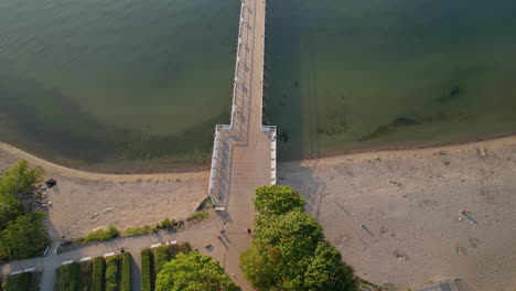 pier of orlowo in gdynia, poland, is bathed in ethereal light of sunrise