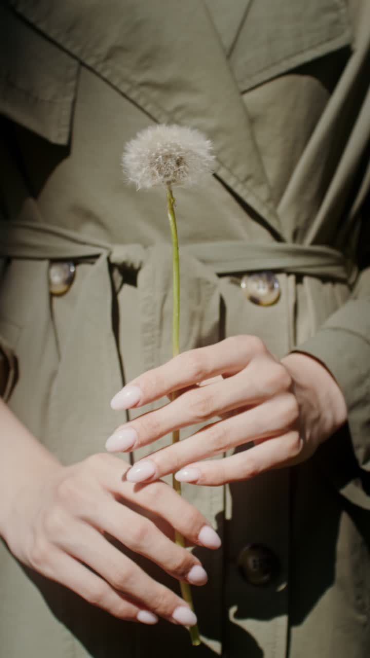 Woman holding a dandelion