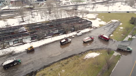 aerial view revealing snow removal trucks cleaning up roads after december 2022 north american deadly winter storm, buffalo, new york, usa