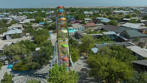 colorful ferris wheel with rust at deserted theme park in sayram near shymkent in kazakhstan