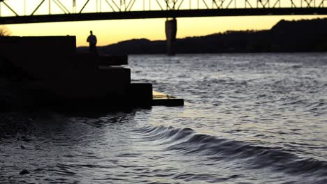 a silhouetted man and woman take pictures and have a good time
