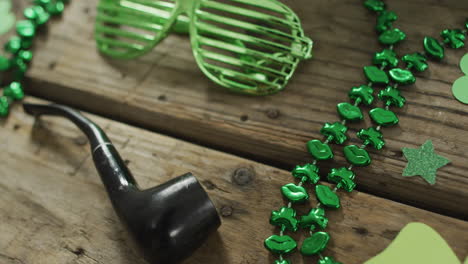 shamrocks and glasses with pipe with copy space on wooden table