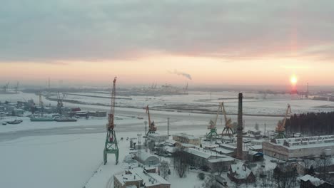 fly over aerial view of industrial port in winter, covered with show