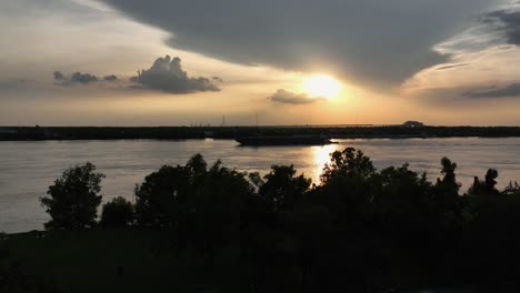 aerial approach towards a working barge at sunset