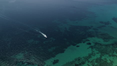 boat sailing in clear aegean sea waters