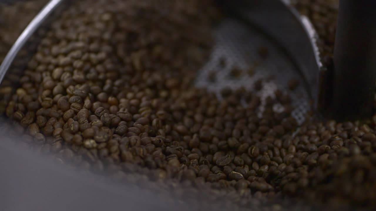 Roasting dark whole coffee beans close up