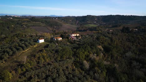 Fast-aerial-dolly-above-vibrant-autumn-fall-colored-hills-of-Tuscany-at-midday