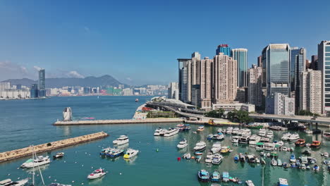 a harbor filled with lots of boats next to tall buildings
