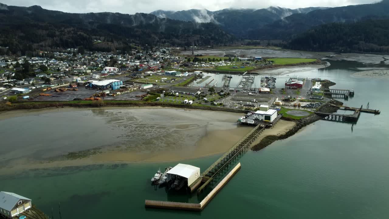 US, Oregon, Garabaldi, , 2025-03-18 - Drone view of the city, the marina, and the mountains. The foreground is the historic Coast Guard Lifeboat Launch, and the center one is the modern Coast Guard