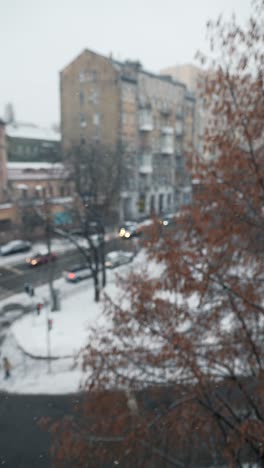 snowy cityscape view from a window