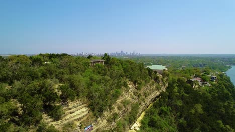 drone footage panning quickly left to right at covert park at mount bonnell with the city of austin, texas in the background