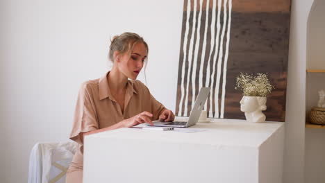 woman works on laptop and numeric keyword at home office