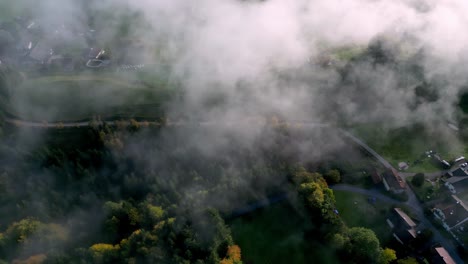 aerial, sky is covered in a thick layer of fog, creating a moody and mysterious atmosphere