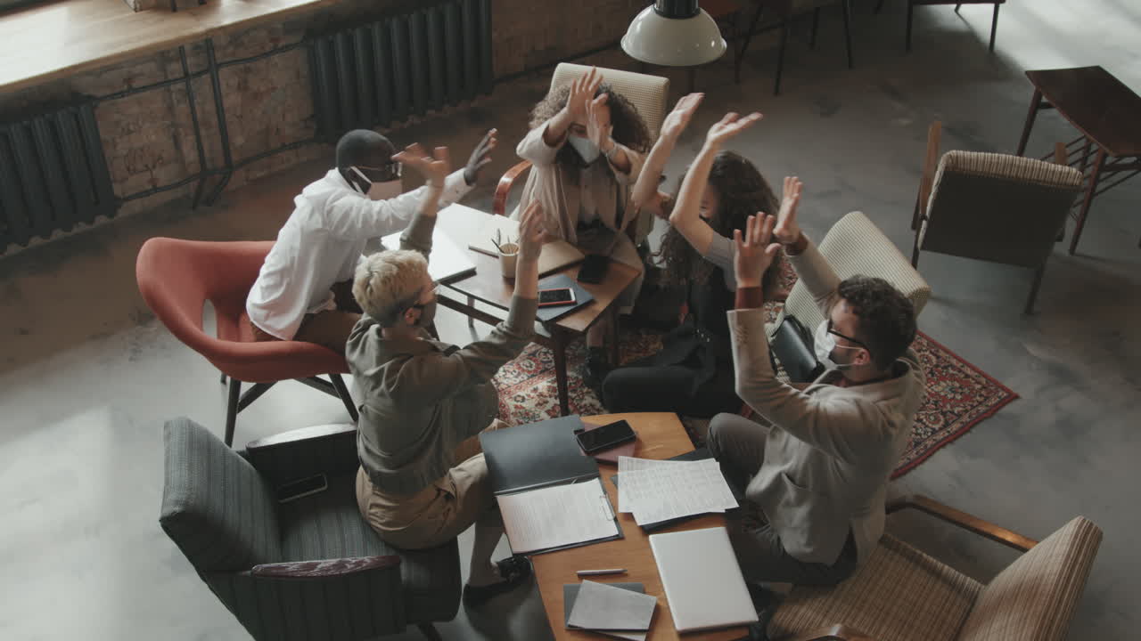 Top-View of Coworkers in Face Masks Putting Hands Together in Middle