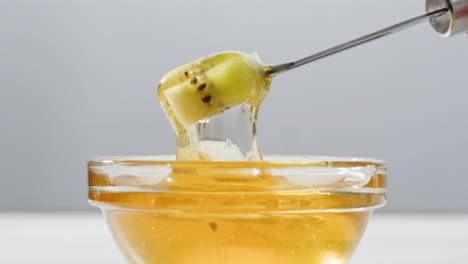 kiwi in honey with a fork