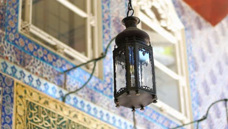 closeup of an ornate lantern hanging inside a mosque