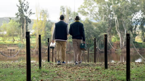 men, friends and walking by lake