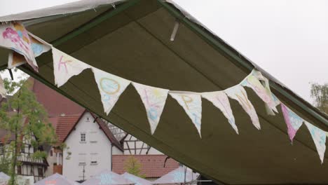 A-chain-of-pennants-with-the-letters-"Kolping"-hangs-from-a-tent-in-a-tent-camp