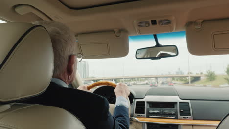 businessman in a suit rides a representative sedan