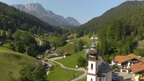 aerial pullback reveals maria gern church in bavaria, germany on summer day