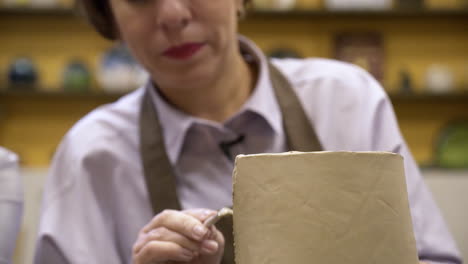 woman shaping clay vessel