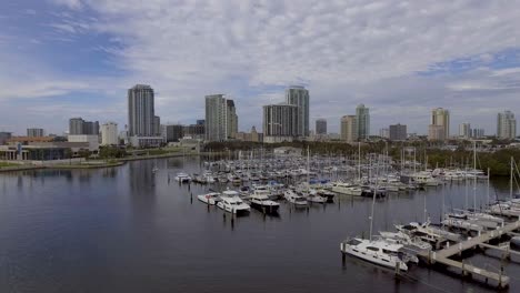 4k aerial drone video of sailboats at marina on tampa bay and skyline of high-rise condos in downtown st