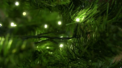 close up christmas tree with decorated led lights glowing, seasonal livingroom decoration