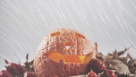 White-light-trails-falling-over-halloween-carved-scary-pumpkin-against-white-background