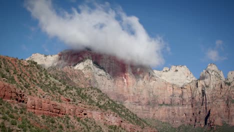 clouds hang low over a mountain top