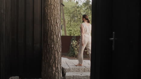 woman walking through a modern garden