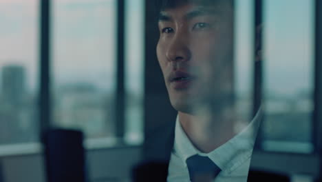 successful asian businessman looking out window proud ceo planning ahead thinking of ideas for future investment strategy corporate manager enjoying leadership career in office