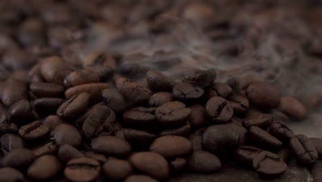 roasted coffee beans with smoke. steam close-up.