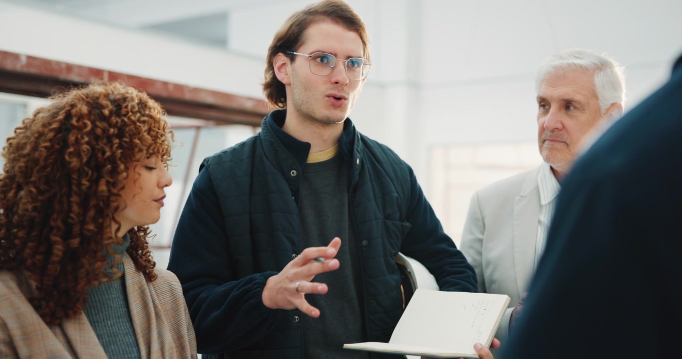 Young Professional Leading a Team Meeting in a Modern Office