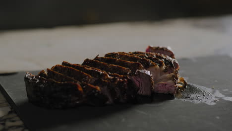 Sliced-steak-sitting-on-a-cutting-board