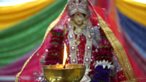 lit brass lamp with hindu goddess durga mata ji at celebration of navratri 1