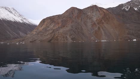 isfjord, svalbard, norway, panoramic view of cold north sea water and snow capped hills on coastline