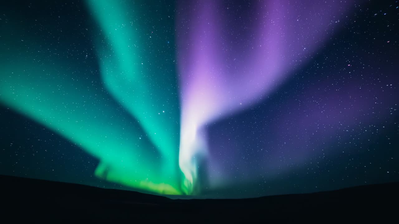 Aurora following solar flare expanding green-purple glow over polar tundra at night with star field