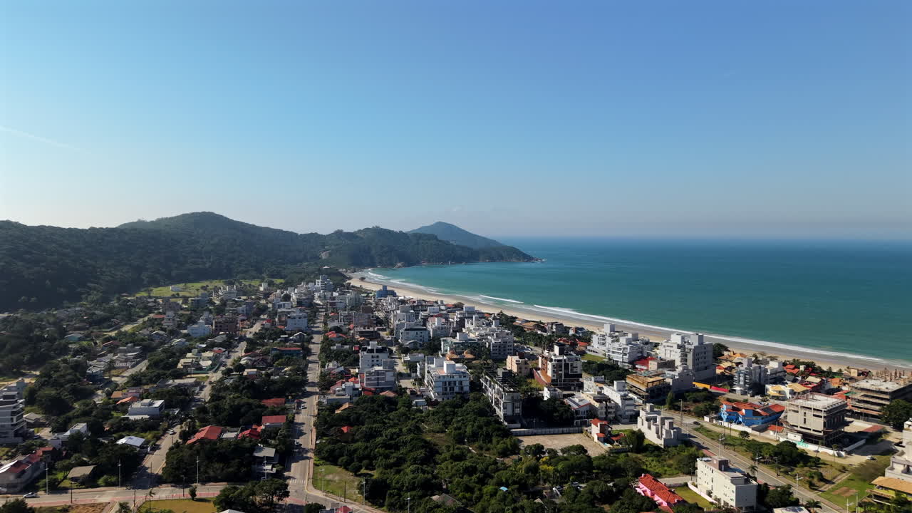 Aerial fly Mariscal Beach, Resort town, White Sand Coastline in Santa Catarina, Brazil