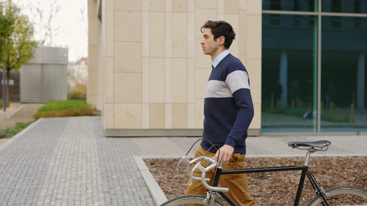 Man walking with his bicycle in an urban setting
