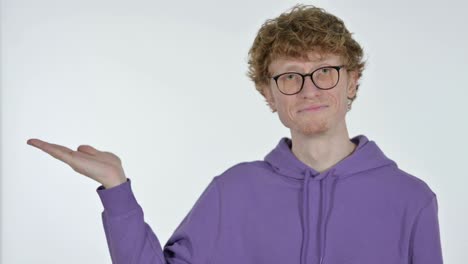 copy space, redhead young man showing product on hand, white background