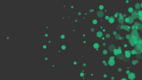 brillos verdes y partículas sobre fondo negro