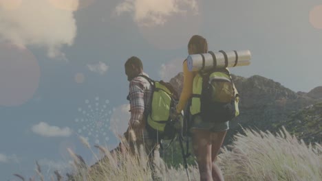 Multiple-light-spots-and-abstract-geometric-shapes-floating-against-african-american-couple-hiking