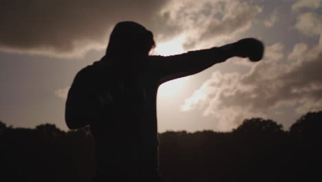 close up shot of man boxing in the park in slow motion