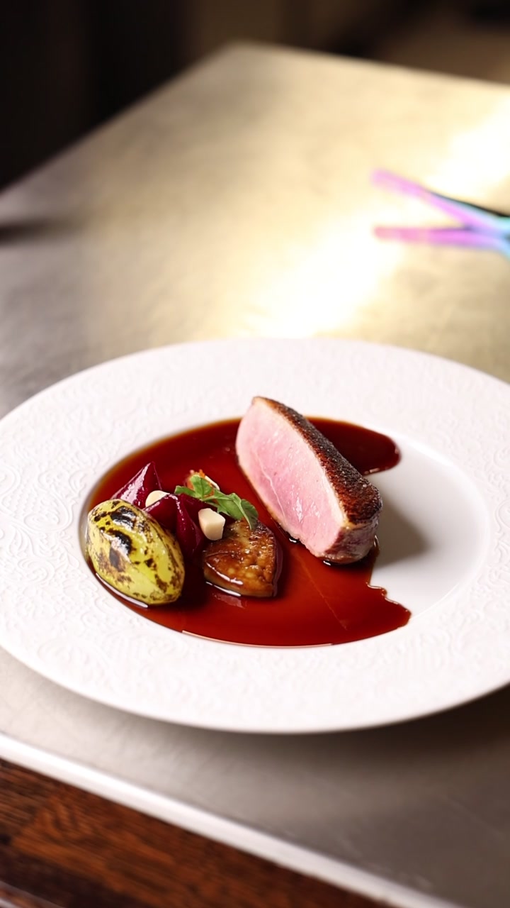 Gourmet Duck Breast Dish Plated on a White Plate