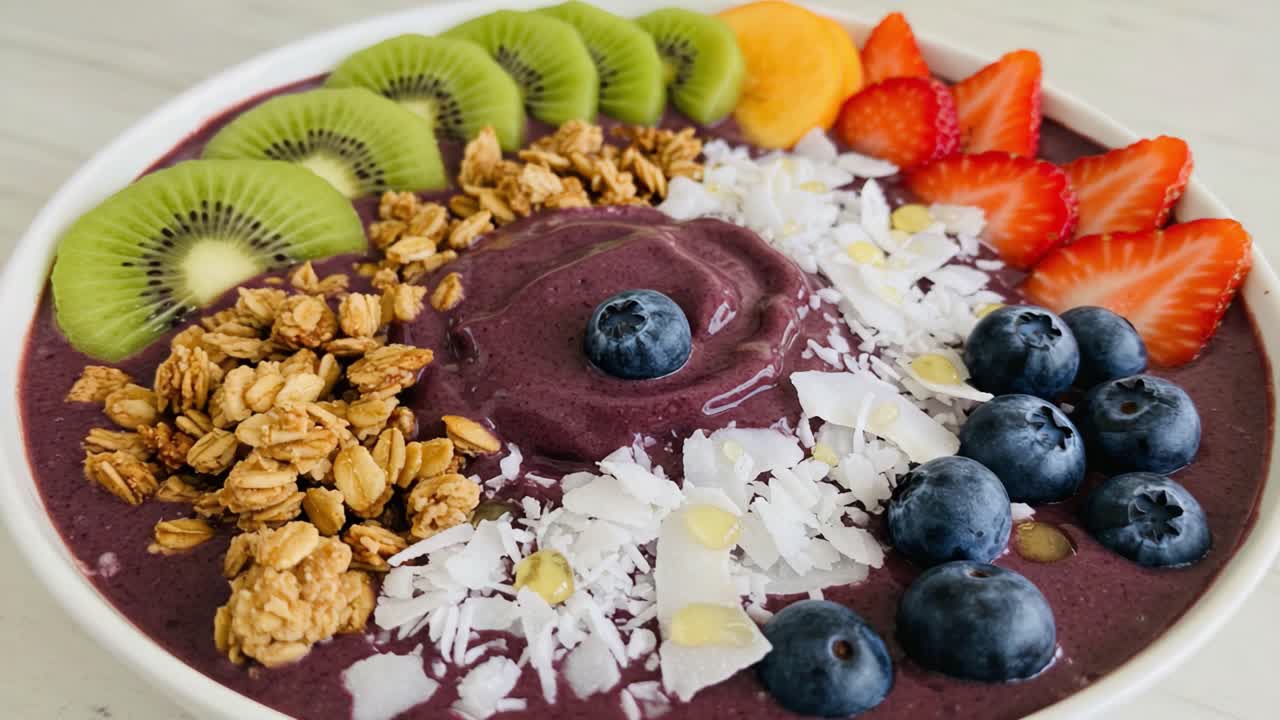 Delicious and Colorful Smoothie Bowl Topped with Fresh Fruits, Granola, and Coconut Flakes, Offering a Healthy and Nutritious Breakfast Option