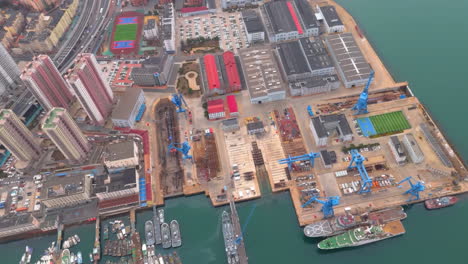 top view ship import export business commercial port in deep sea load and unloading cargo by crane for distributing goods at downtown city near highway main road