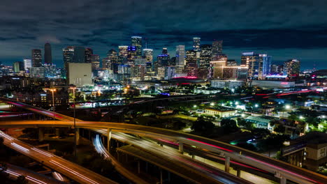 aerial drone hyperlapse of houston city at night, highway i45 junctions i69 rush hour traffic, light trails and skyline